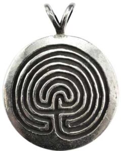 A silver pendant featuring a labyrinth design inspired by Celtic motifs.