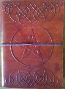 A wooden cover featuring intricate Celtic knotwork and a central pentagram symbol, bound with a leat.