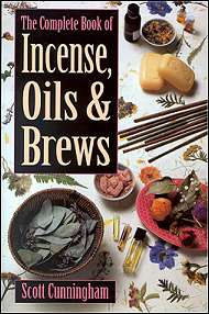 A variety of herbs, oils, and incense sticks displayed on a table.