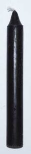 A close-up of a black ink stick used for traditional calligraphy and spiritual practices.