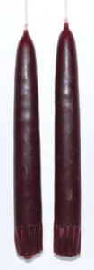 Red candles with subtle Celtic design elements.