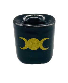 Celtic triple moon symbol on a black candle for spiritual practices.