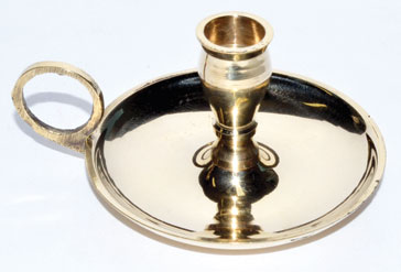 A brass candle holder with a circular base and a central holder for a candle.