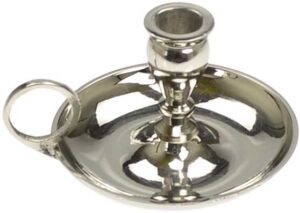 Silver candle holder with a round base and a central holder for a candle, reflecting Celtic spiritua.