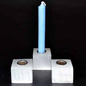 Candle holder with blue candle, simple design, on a black background.