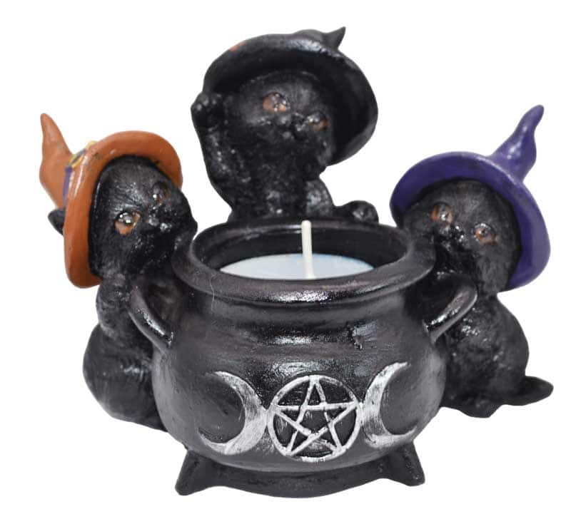Cauldron with three small witch hats, featuring a pentagram symbol, used for Celtic spiritual practi.