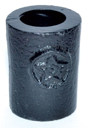 Small black cylindrical ogham stone with carved symbols, related to Celtic spirituality and druidry.