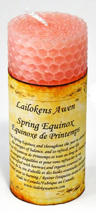 Candle with honeycomb pattern and a label reading "Lailokens Awen Spring Equinox.".