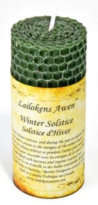 Celtic winter solstice candle with honeycomb design and a printed label.