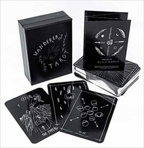 Modern tarot deck with Celtic-inspired designs and black packaging for spiritual guidance.