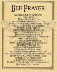 Close-up of a printed bee prayer on aged paper, emphasizing spirituality and nature.