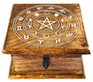 A wooden box featuring a pentagram and zodiac symbols engraved on the lid.
