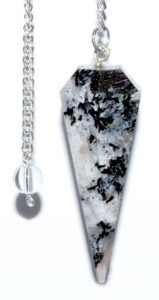 Pendulum with black and white speckled stone on silver chain.
