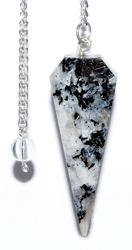 Pendulum with black and white speckled stone on silver chain.