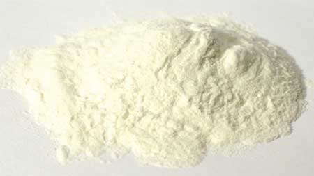 Fine white powder, possibly flour or chalk, on a plain background.