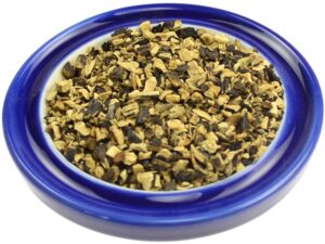 Close-up of herbal mixture in a blue bowl, used in Celtic spiritual practices.