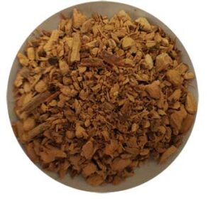 Dried herbal mixture with small, irregularly shaped pieces in a white bowl.