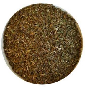 Herbal mixture with dried leaves and plant material in a round container.