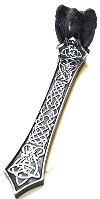 A detailed image of a dagger featuring Celtic knotwork and a black carved handle.
