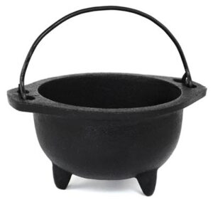 Small black cauldron with handle, used in Celtic spiritual practices and rituals.