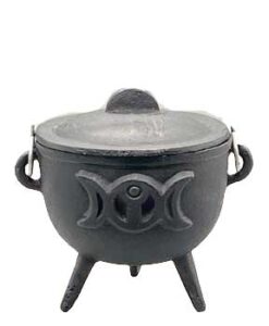 Traditional black cauldron with ogham carvings, used in Celtic spiritual practices.