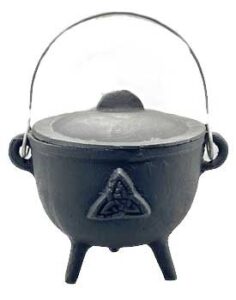 Small black cauldron with a triangular knot symbol, metal handle, and three legs, used in Celtic spi.