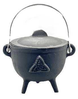 Small black cauldron with a triangular knot symbol, metal handle, and three legs, used in Celtic spi.
