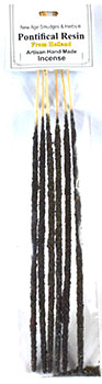 A close-up of a bundle of incense sticks with black and white stripes, ready for use in spiritual or.