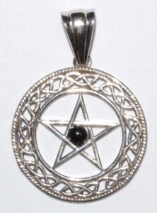 Silver Celtic pendant with pentagram and intricate knotwork design, featuring a central black stone.