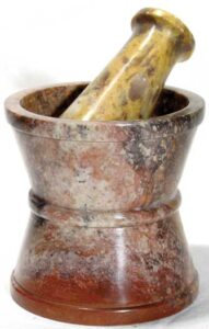 Stone mortar and pestle used for traditional herbal preparation.