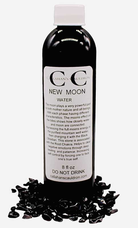 Bottle of New Moon Water with black stones around base.
