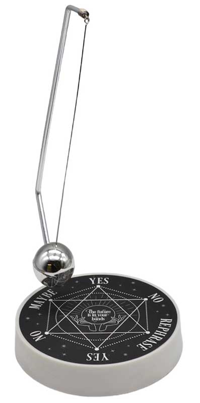 A metal pendulum hanging above a circular board with spiritual symbols and words.