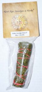Cedar smudge stick in plastic packaging, used for spiritual cleansing and nature-based practices.