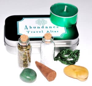 Travel altar with candles, stones, and natural objects for Celtic spirituality practices.