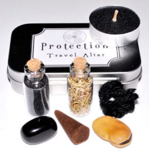 Protection Travel Altar with stones, herbs, and a candle for Celtic spiritual practices.