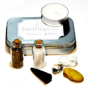Small purification altar with candles, stones, and herbs for Celtic spiritual practices.