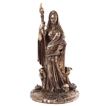 Bronze Celtic goddess statue holding a torch, surrounded by skulls and bones, symbolizing death and.