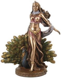 Statue of a Celtic goddess with peacock and foliage, representing nature and spiritual connection.