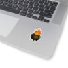 A sticker featuring a black cauldron with a swirling symbol and bright orange flames, placed on a silver laptop.