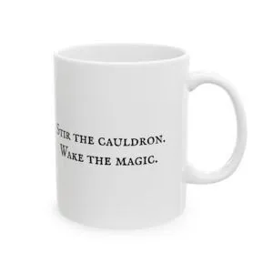 White ceramic mug with black text "Stir the cauldron. Wake the magic.".