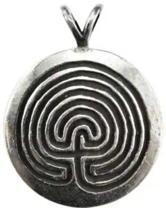 A silver pendant featuring a labyrinth design inspired by Celtic motifs.
