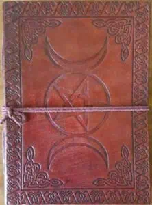 Leather-bound Celtic ogham book with knotwork border and tied cord closure.
