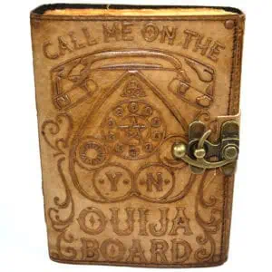 Wooden Ouija board with planchette and engraved symbols, used for spiritual communication.