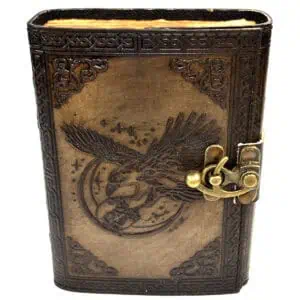 Leather journal with eagle design and metal clasp, Celtic-style border details.