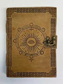 Old book with Ogham symbols and a metal lock, related to Celtic spirituality and druidry.