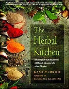 Assorted herbs, spices, and natural ingredients on a rustic wooden surface.