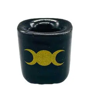 Celtic triple moon symbol on a black candle for spiritual practices.