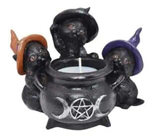 Cauldron with three small witch hats, featuring a pentagram symbol, used for Celtic spiritual practi.
