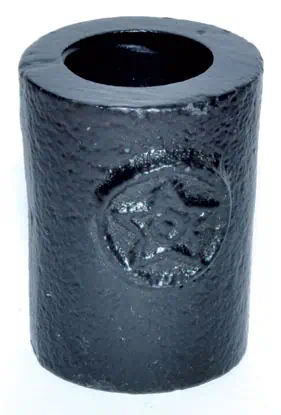 Small black cylindrical ogham stone with carved symbols, related to Celtic spirituality and druidry.