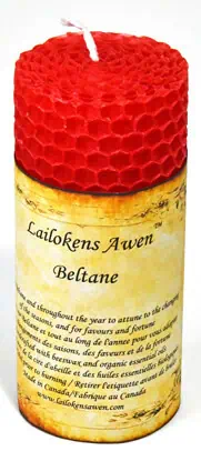 Red beeswax candle with honeycomb pattern, used in Celtic spiritual practices and rituals.